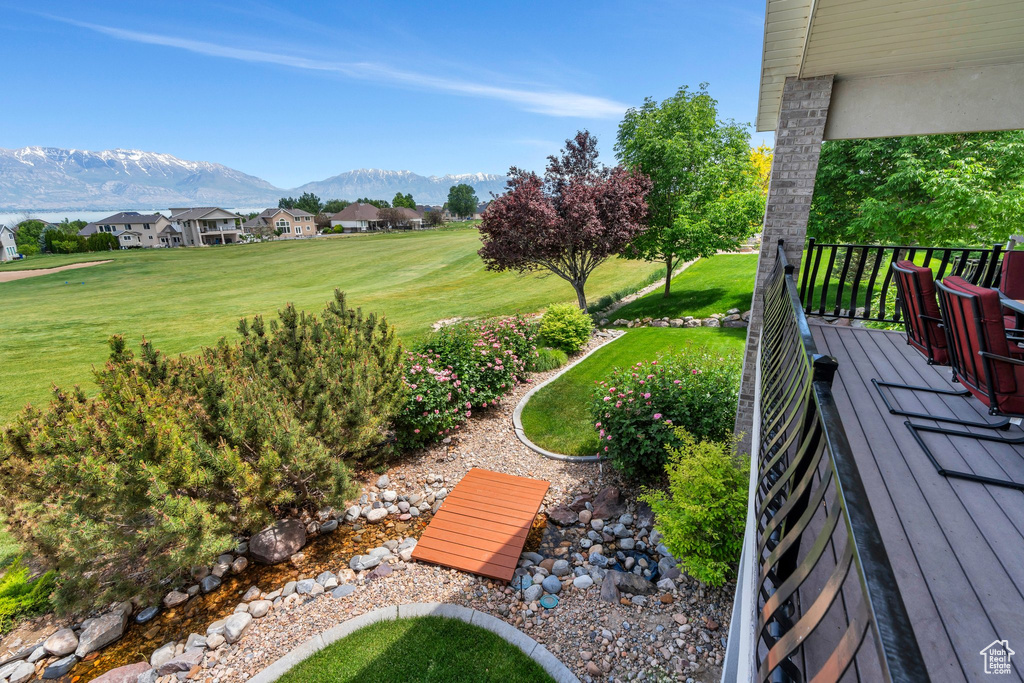View of grassy yard with a mountain view and a residential view