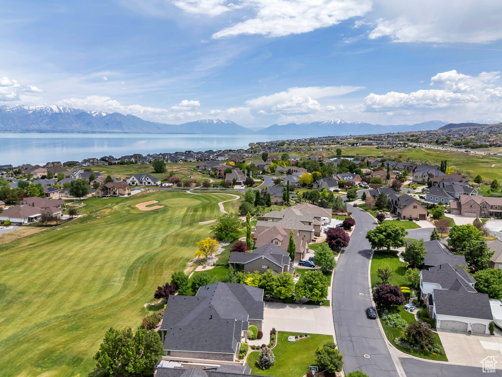 Aerial perspective of suburban area featuring a water and mountain view and a local golf course