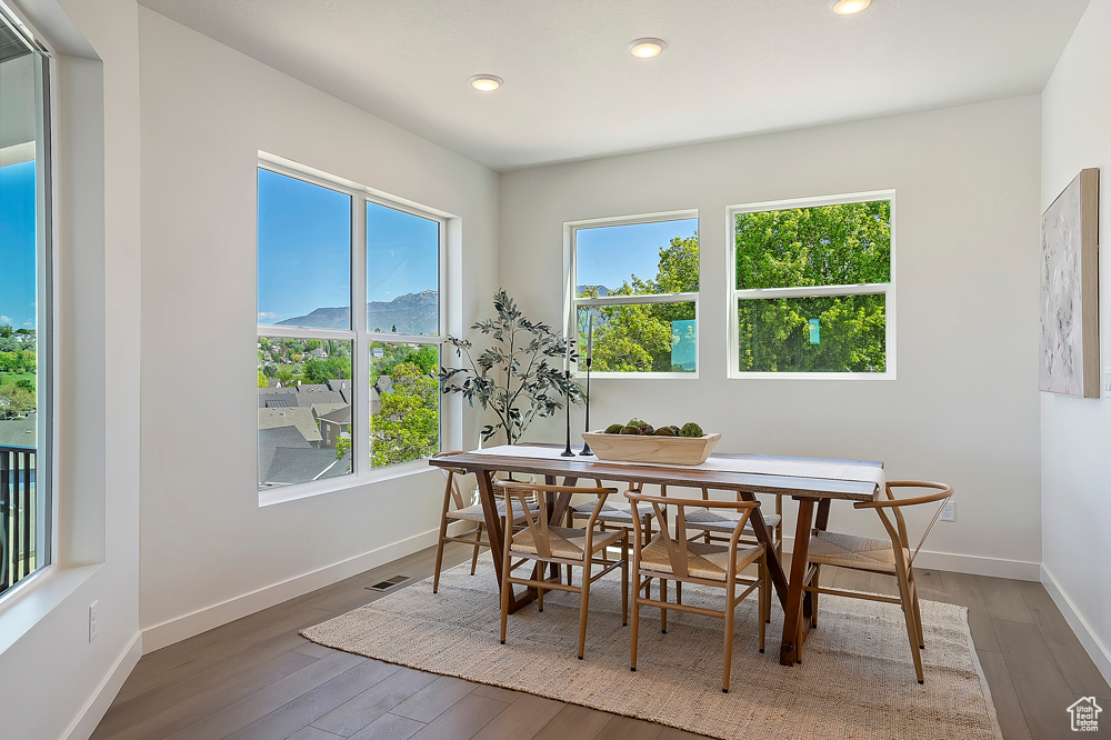 Dining room featuring wood finished floors, baseboards, and recessed lighting