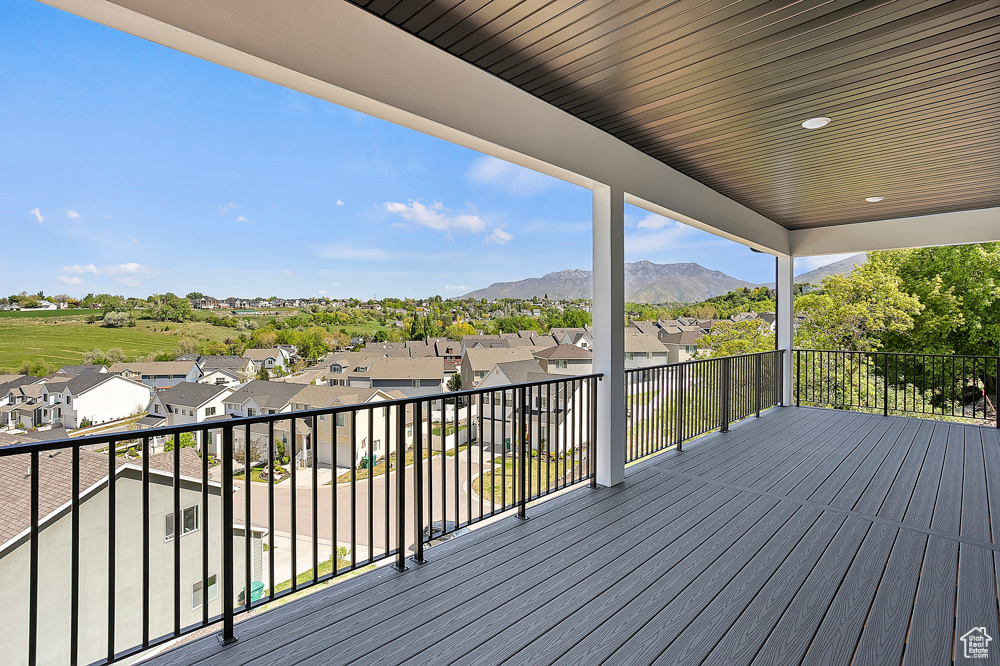 Wooden terrace featuring a residential view and a mountain view