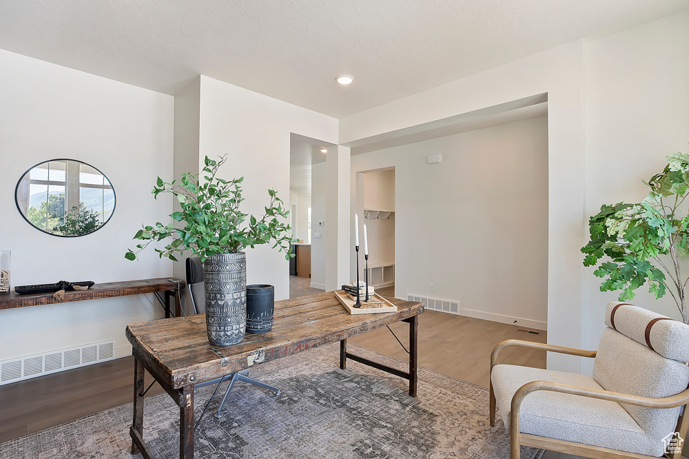 Office space featuring wood finished floors, baseboards, and recessed lighting