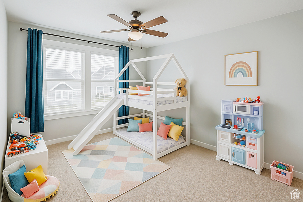 Bedroom featuring light carpet and baseboards