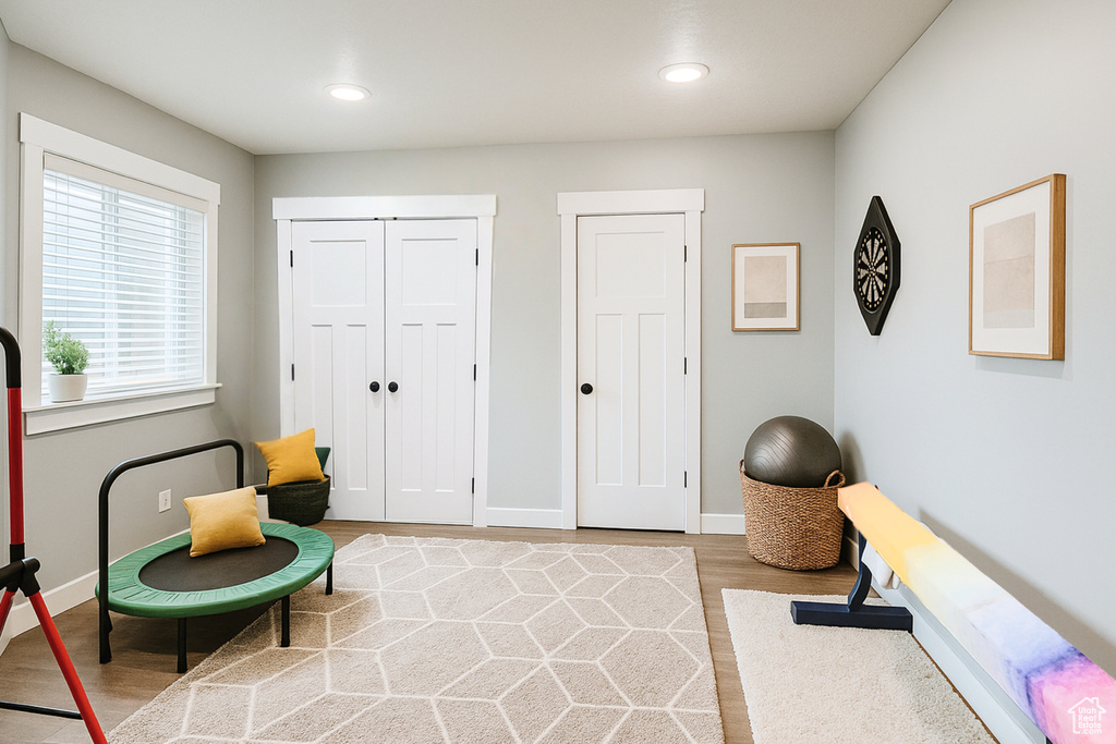 Living area featuring light wood finished floors, baseboards, and recessed lighting