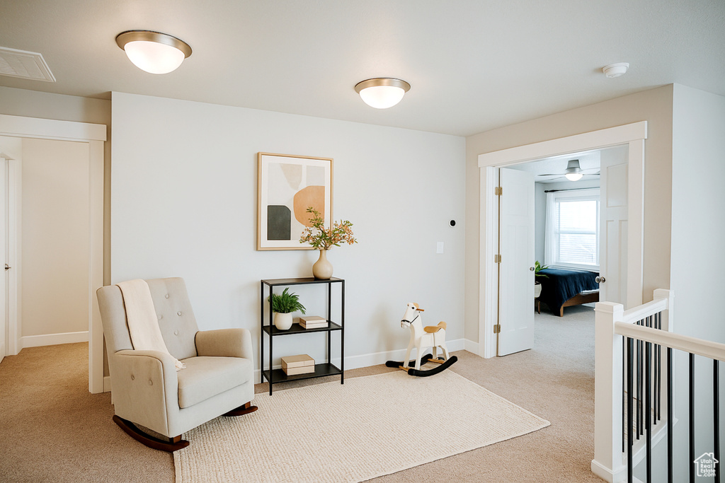 Living area with carpet and baseboards