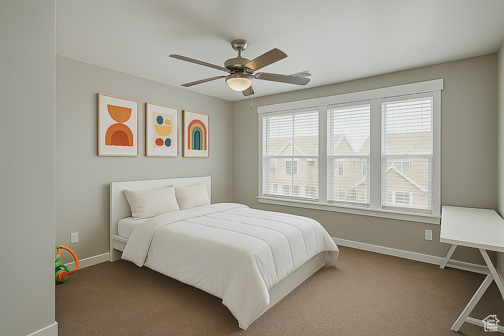 Carpeted bedroom with baseboards and ceiling fan