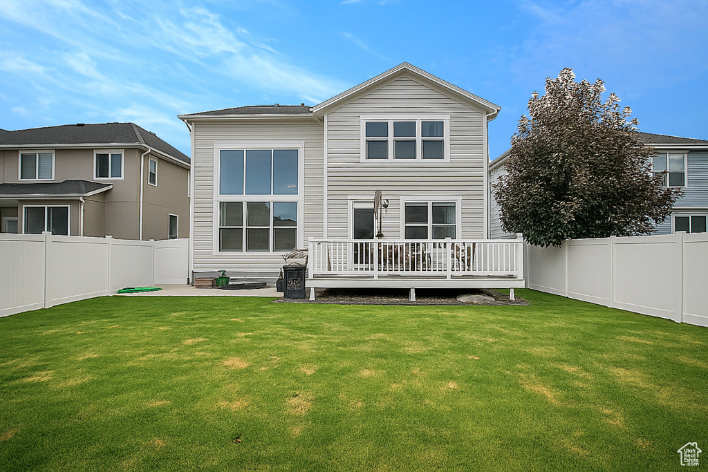 Back of property with a wooden deck