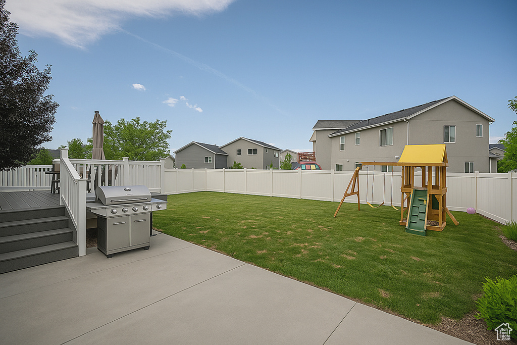 View of yard with a patio area, a playground, a residential view, and a deck