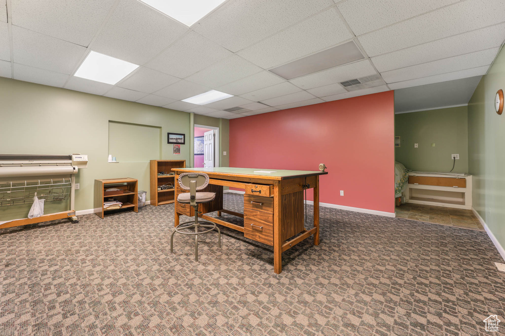 Carpeted office space with baseboards and a drop ceiling