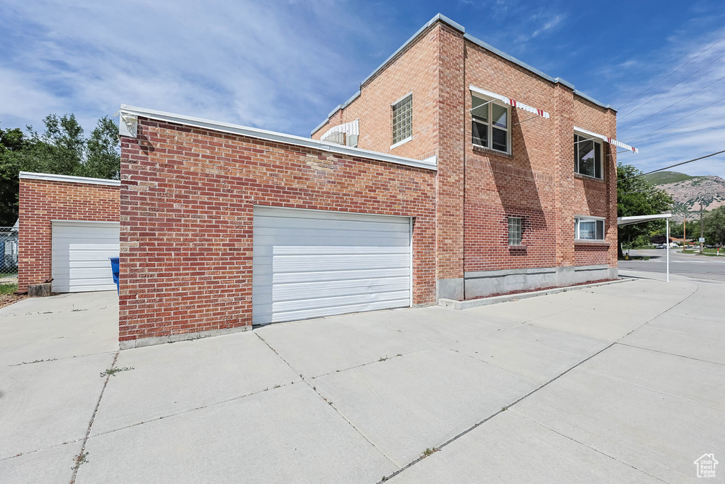 View of home\\\'s exterior featuring brick siding and concrete driveway