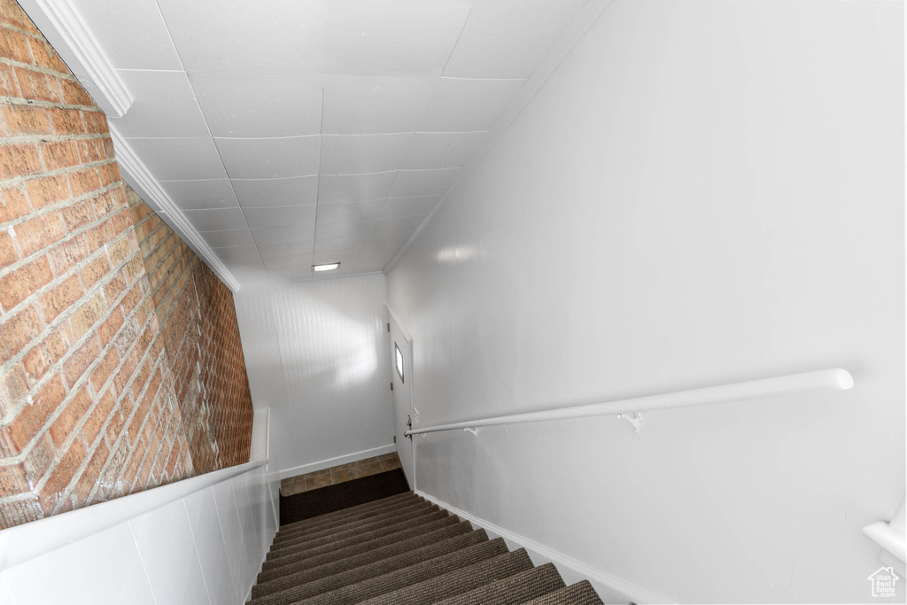 Stairway with brick wall and carpet