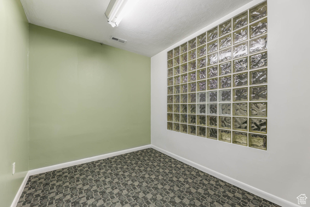 Empty room with baseboards and carpet