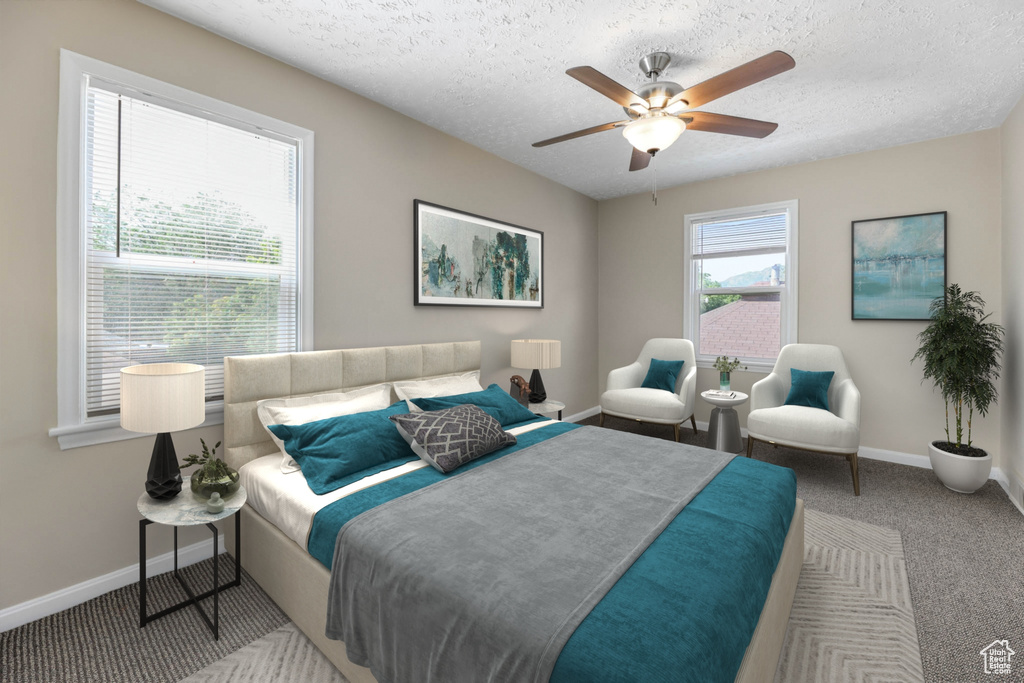 Bedroom featuring baseboards, carpet flooring, a textured ceiling, and a ceiling fan