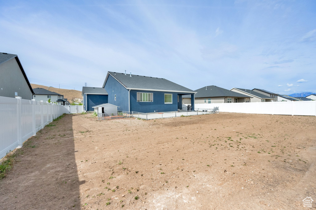 Back of house featuring a fenced backyard