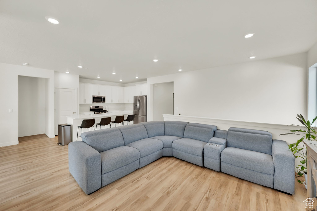Living area featuring light wood-style flooring and recessed lighting
