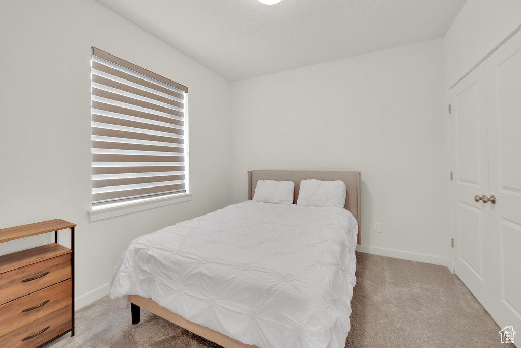 Bedroom with carpet floors and baseboards