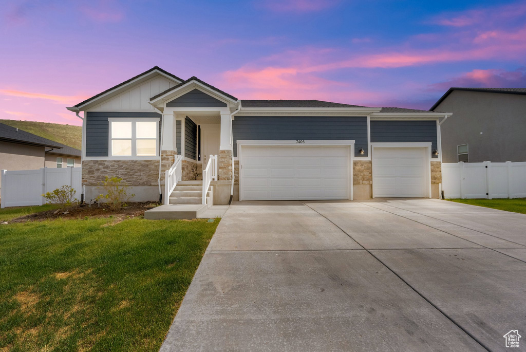 Ranch-style house with stone siding, a garage, and concrete driveway