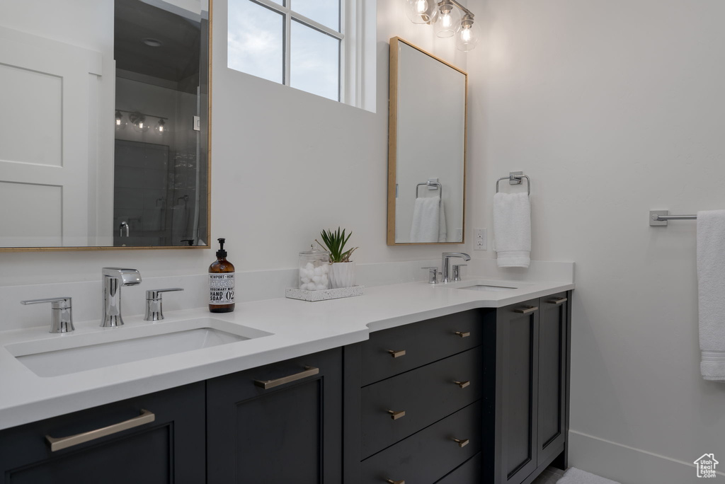 Bathroom with double vanity and a shower with door