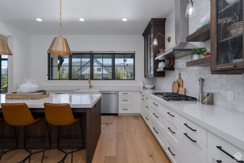 Kitchen with appliances with stainless steel finishes, a sink, plenty of natural light, light countertops, and recessed lighting