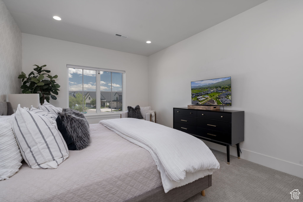 Bedroom featuring light colored carpet and recessed lighting