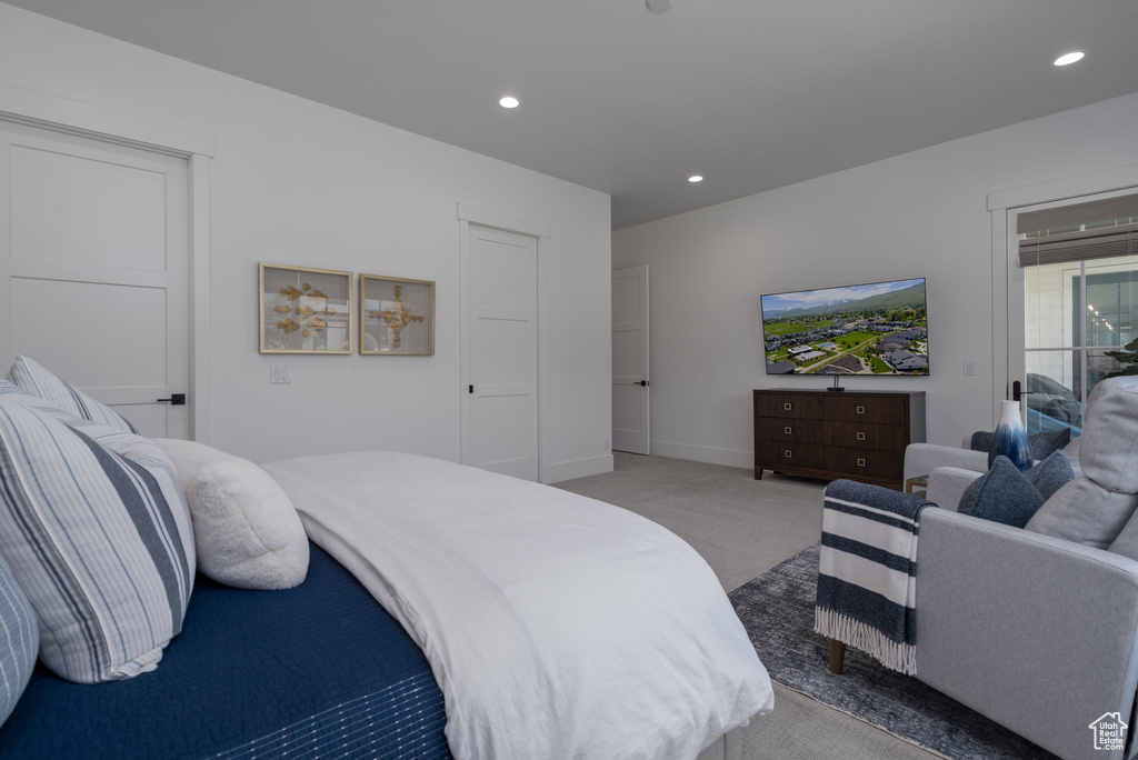 Bedroom with light colored carpet, recessed lighting, and baseboards