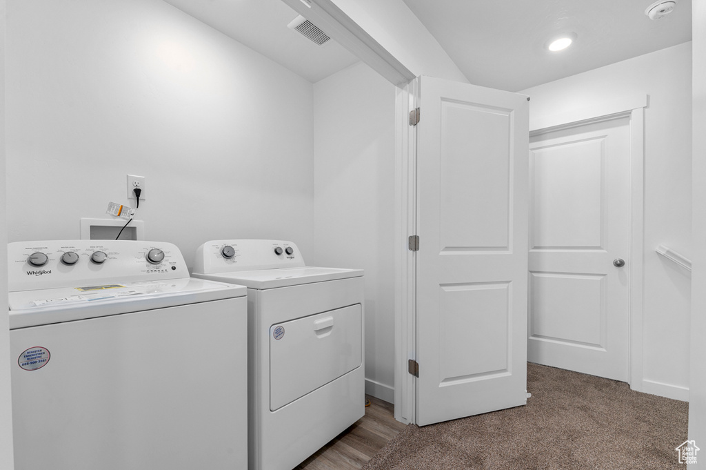 Laundry area with washing machine and clothes dryer and carpet