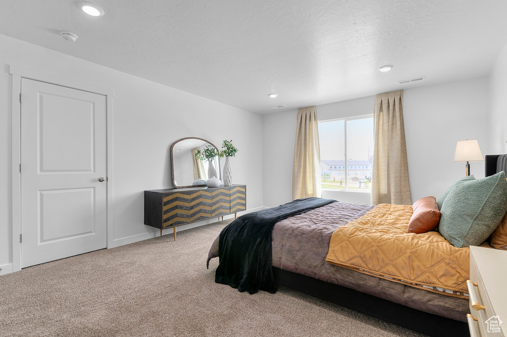 Carpeted bedroom featuring recessed lighting and baseboards