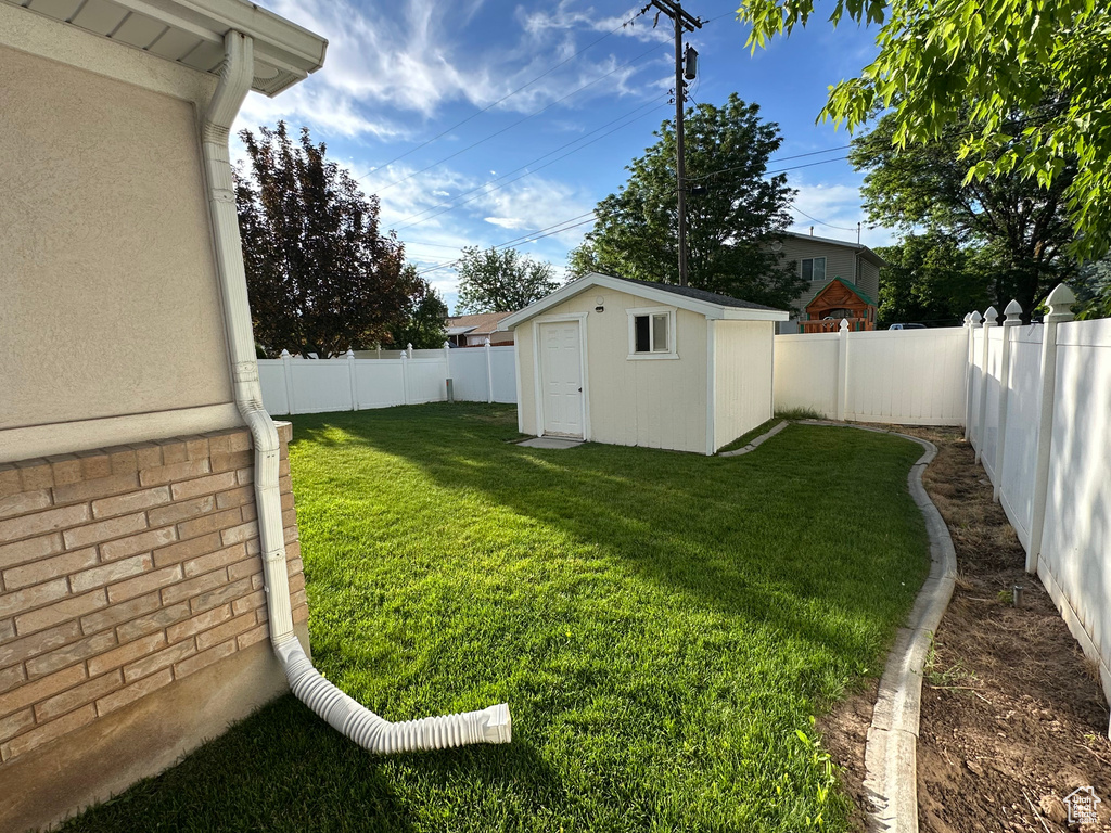 Fenced backyard with a storage shed