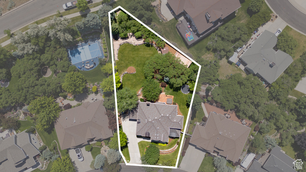 Aerial view of property and surrounding area with nearby suburban area