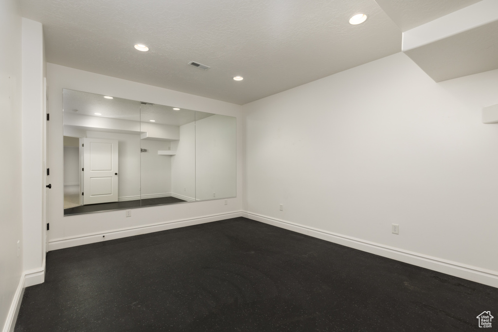 Unfurnished room featuring baseboards and recessed lighting