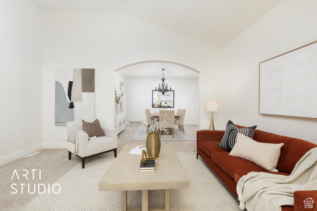 Living area with arched walkways, a chandelier, light carpet, baseboards, and high vaulted ceiling