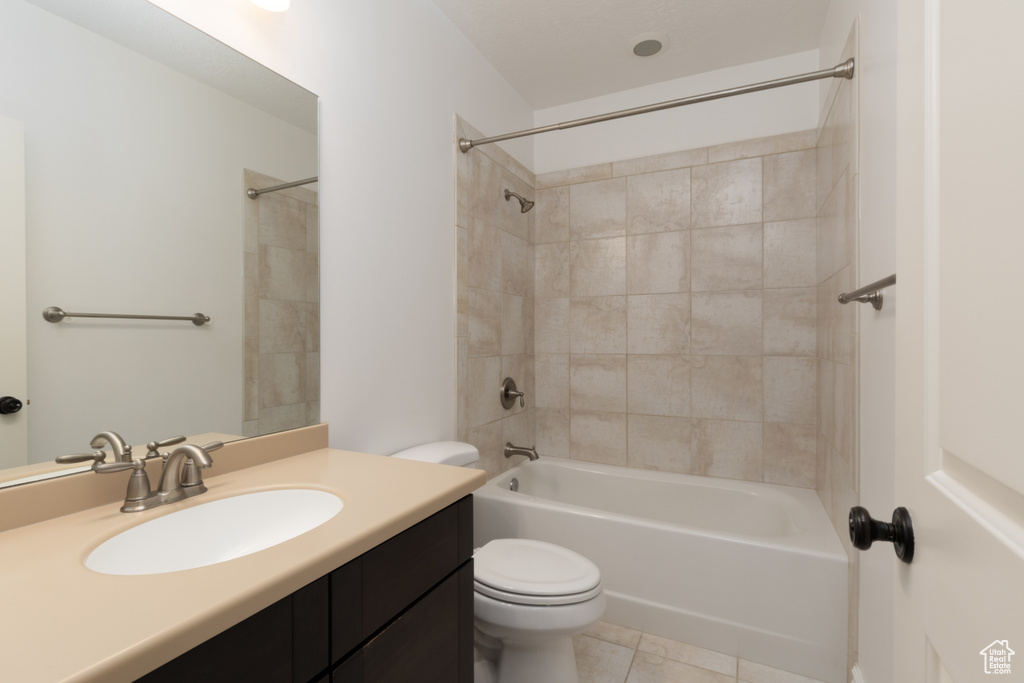 Bathroom with toilet, vanity, shower / tub combination, and tile patterned flooring