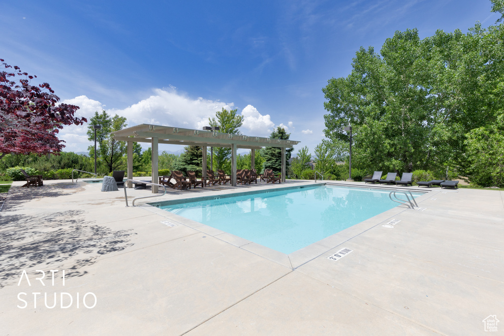 Community pool with a pergola and a patio