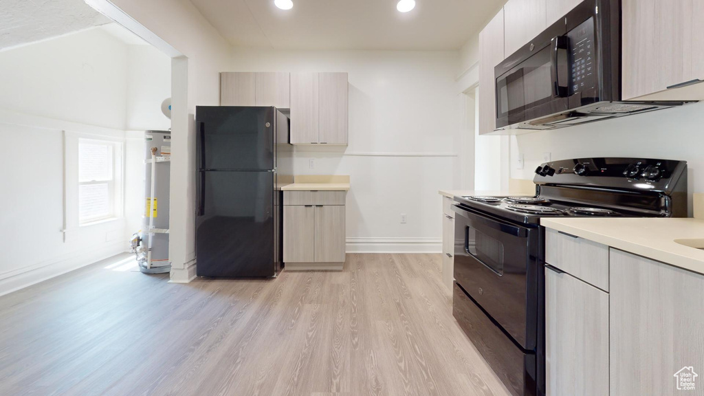 Kitchen with black appliances, modern cabinets, baseboards, and recessed lighting