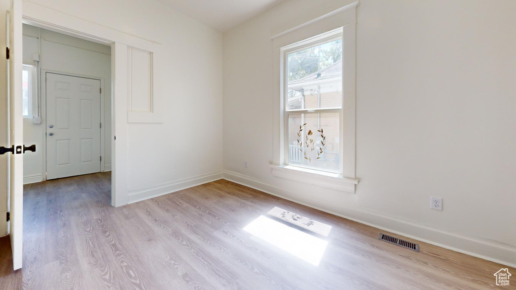 Empty room featuring wood finished floors and baseboards
