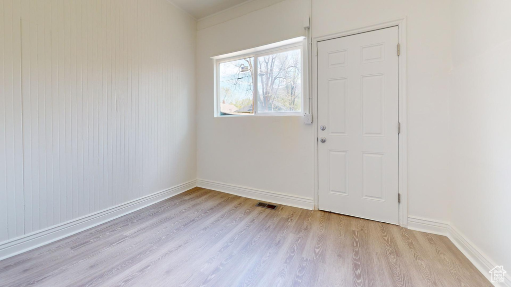 Foyer featuring light wood finished floors and baseboards