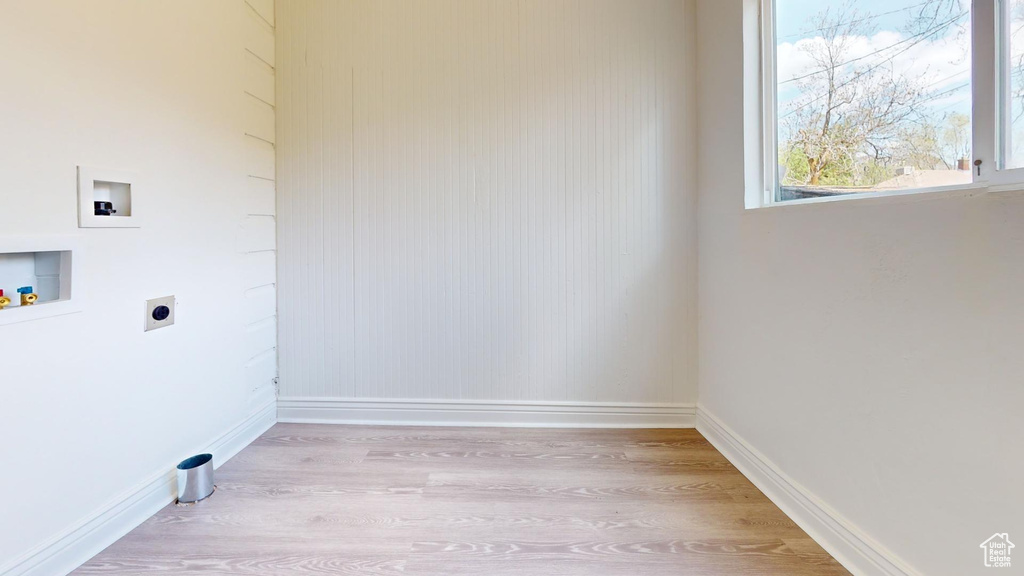 Laundry area featuring electric dryer hookup, washer hookup, baseboards, and light wood finished floors