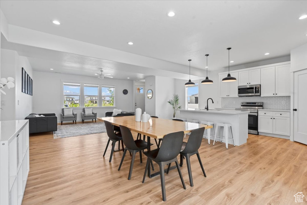 Dining space with light wood-style floors, recessed lighting, and ceiling fan