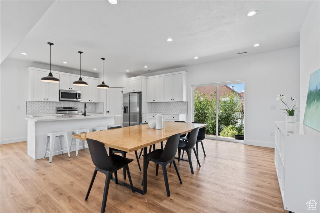 Dining area with recessed lighting, light wood-type flooring, and baseboards