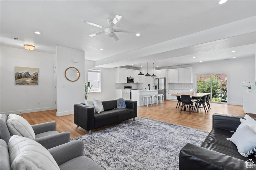 Living area featuring recessed lighting, baseboards, light wood-type flooring, and ceiling fan
