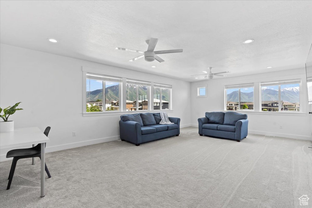Living room with baseboards, recessed lighting, a mountain view, carpet, and a ceiling fan