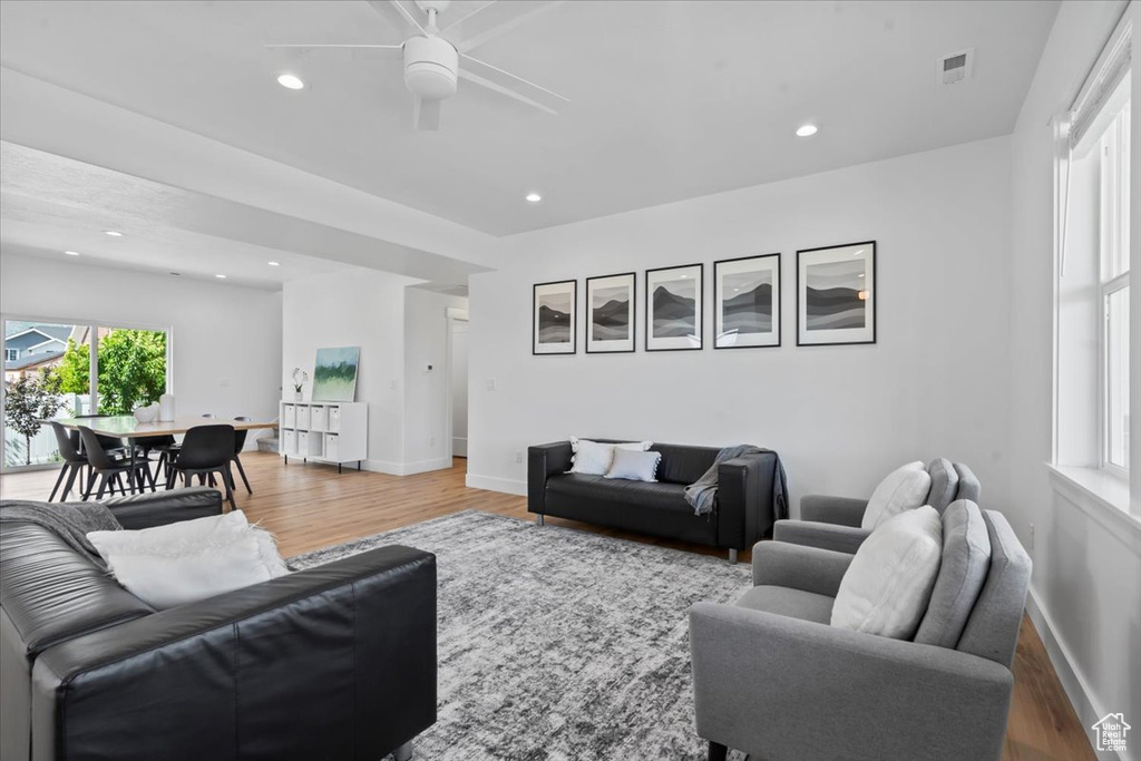 Living area featuring light wood-type flooring, ceiling fan, baseboards, and recessed lighting