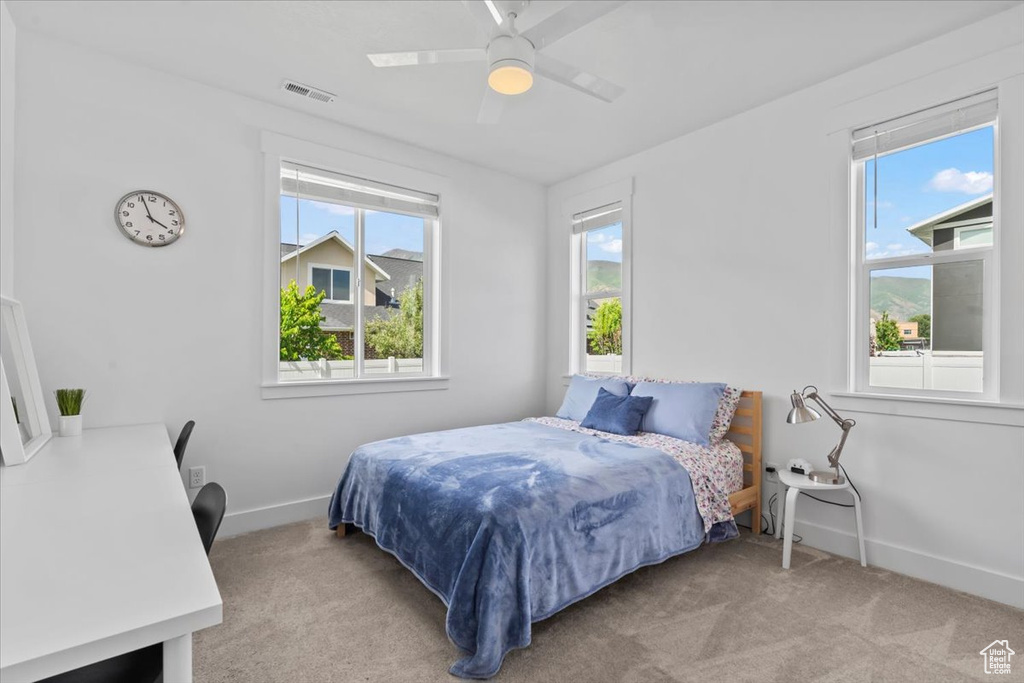 Bedroom with carpet flooring, baseboards, and a ceiling fan