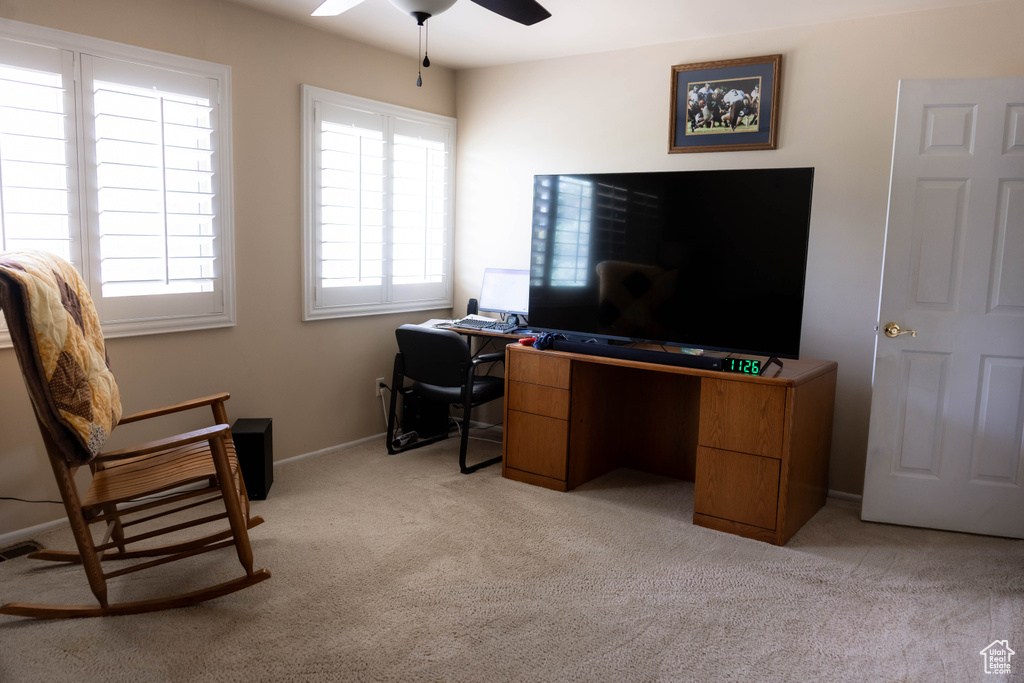 Office space featuring light colored carpet and a ceiling fan