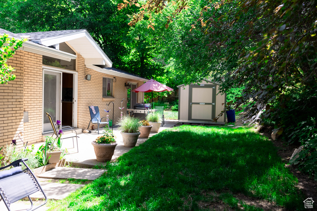 View of grassy yard with a patio