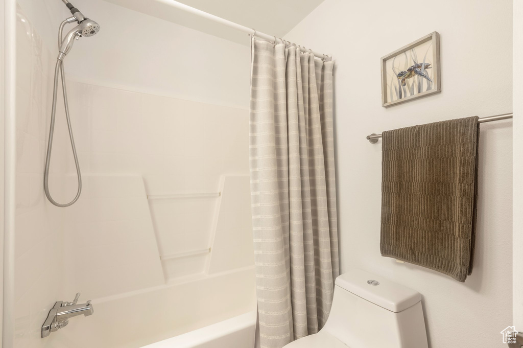 Full bathroom featuring toilet and shower / tub combo
