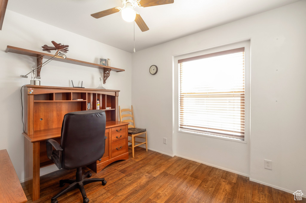 Office area featuring a ceiling fan, wood finished floors, and baseboards