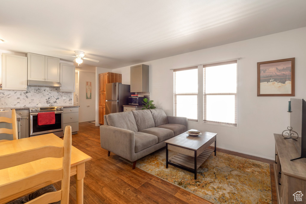 Living room with wood finished floors and ceiling fan