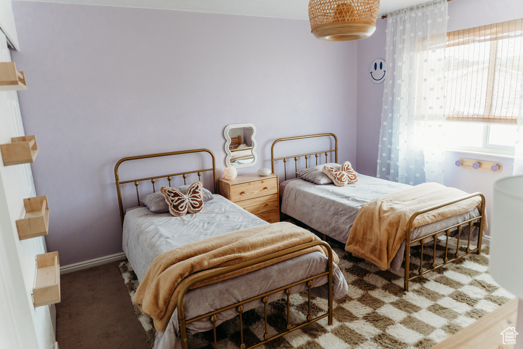 Bedroom with carpet floors and baseboards