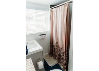 Bathroom featuring vanity, toilet, and a shower with curtain