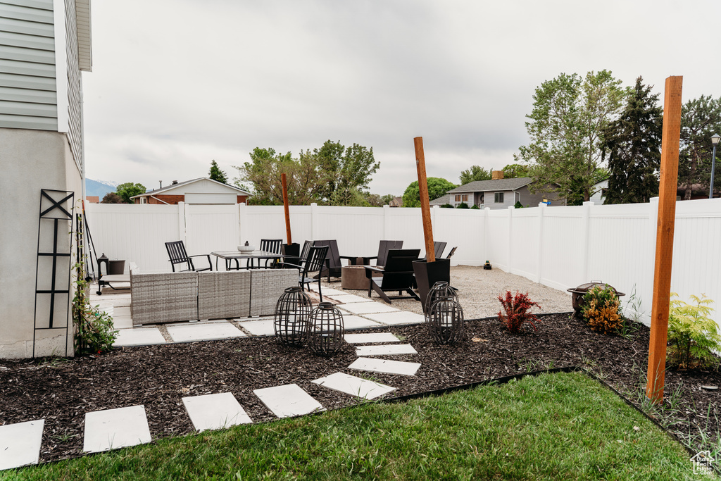 Fenced backyard with a patio area and an outdoor hangout area